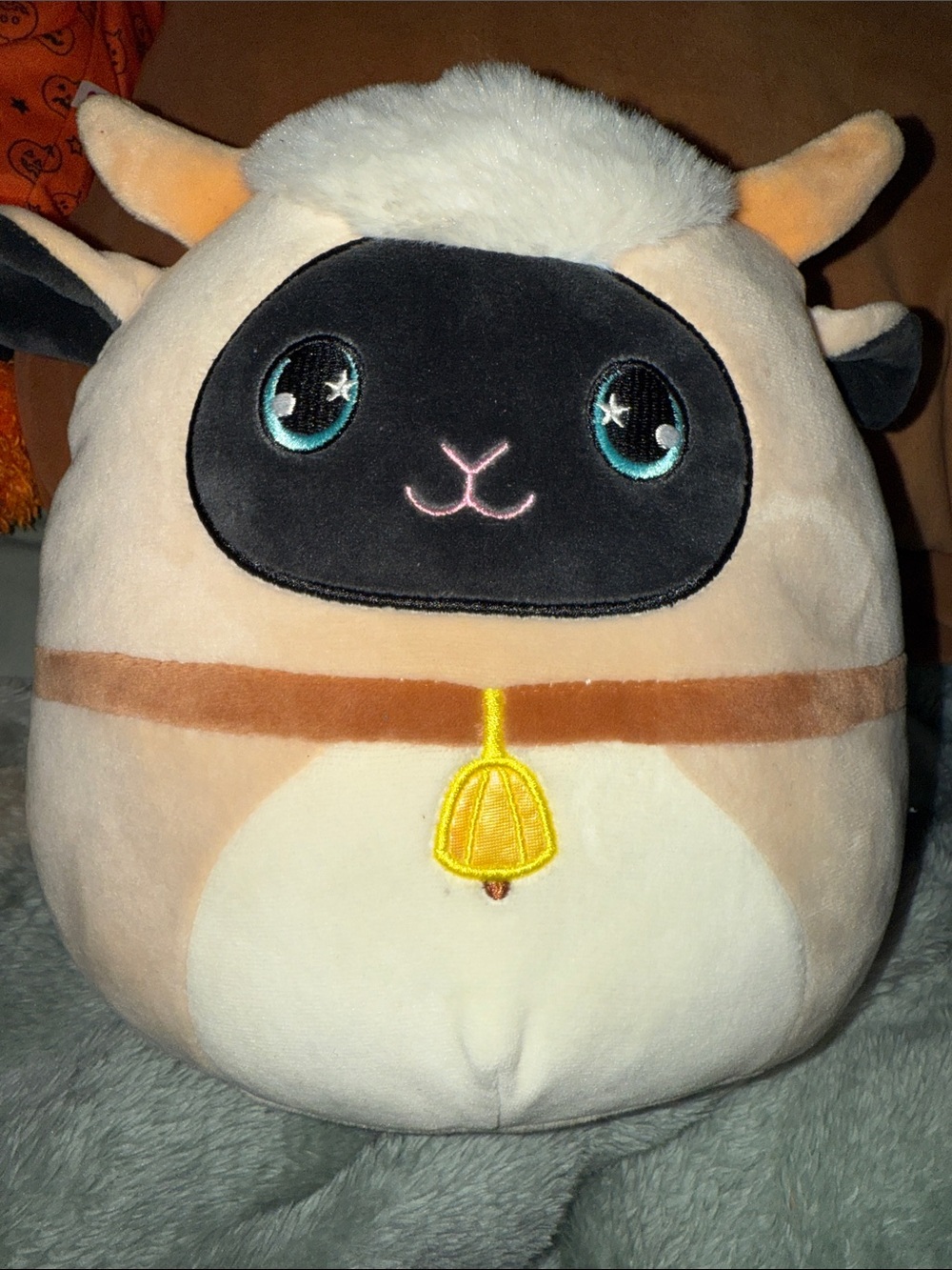 Squishmallows Cream & Black Sheep with Teal Eyes and Yellow Bell